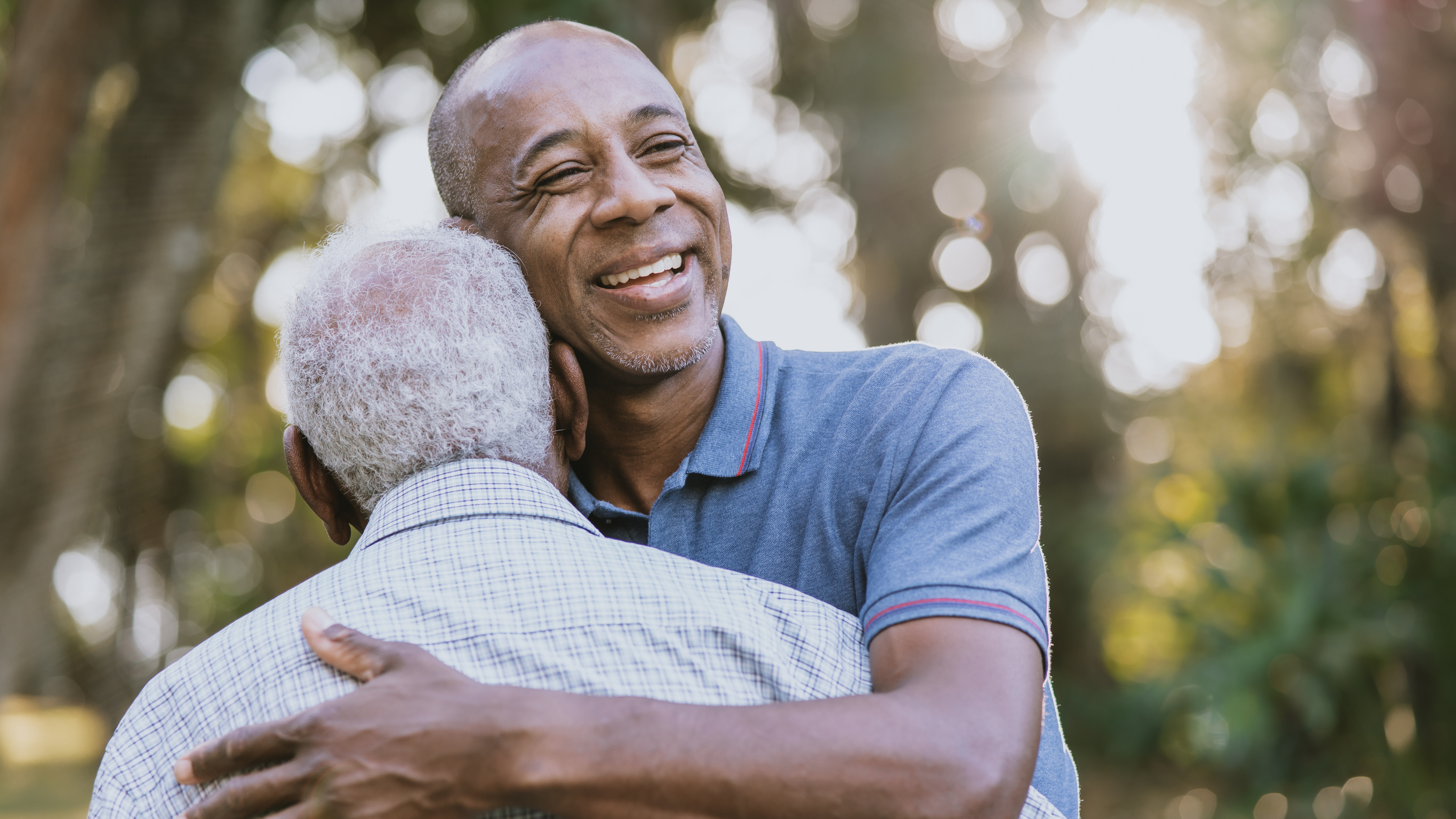 Son hugging his elderly dad.